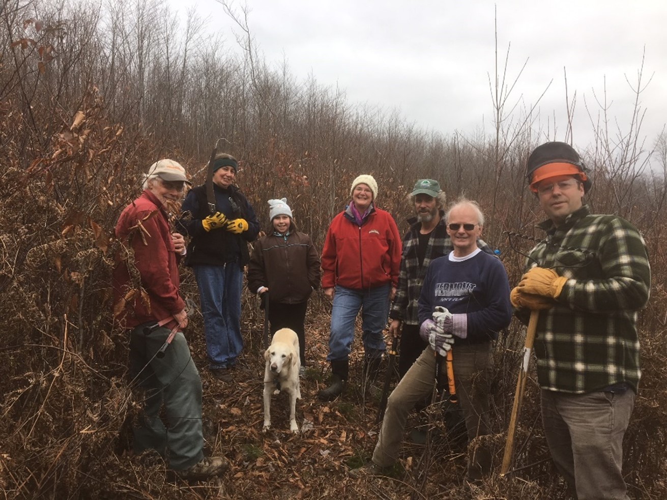 seven people dressed in fall weather clothes, ready for trail work